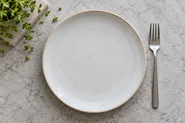 A simple white plate on a table